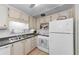 White kitchen with updated appliances and double sink at 18675 Us Highway 19 N # 364, Clearwater, FL 33764