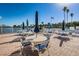 Community patio with tables, chairs, and umbrellas overlooking the water at 18675 Us Highway 19 N # 364, Clearwater, FL 33764