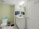 Bathroom with toilet, sink, and linen storage at 1910 E Palm Ave # 8214, Tampa, FL 33605