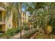 Lush courtyard with tropical landscaping and walking paths at 1910 E Palm Ave # 8214, Tampa, FL 33605