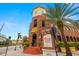 Brick building exterior with palm trees and street view at 1910 E Palm Ave # 8214, Tampa, FL 33605