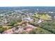 Aerial view of community with houses and surrounding landscape, providing context of the location at 1962 Freedom Dr, Clearwater, FL 33755