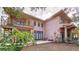 Back patio with wooden deck and stairs leading to the second floor at 1962 Freedom Dr, Clearwater, FL 33755