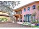 Backyard patio with wooden deck and stairs to second-floor balcony at 1962 Freedom Dr, Clearwater, FL 33755