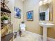 Guest bathroom with pedestal sink and decorative accents at 1962 Freedom Dr, Clearwater, FL 33755