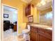 Bathroom features a toilet, sink, and vanity with access to an office at 1962 Freedom Dr, Clearwater, FL 33755