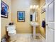 Updated bathroom with pedestal sink and tiled floor at 1962 Freedom Dr, Clearwater, FL 33755