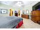 Large bedroom with dresser, TV, and ensuite access at 1962 Freedom Dr, Clearwater, FL 33755