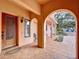 Inviting entryway with an arched alcove, decorative door, and tile flooring at 1962 Freedom Dr, Clearwater, FL 33755