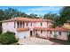 Two-story pink stucco house with tile roof and two-car garage at 1962 Freedom Dr, Clearwater, FL 33755