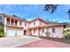 Two-story stucco home with a tile roof, two-car garage, and landscaped grounds at 1962 Freedom Dr, Clearwater, FL 33755