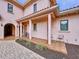 Elegant entryway with a covered porch, tile flooring, and arched entry at 1962 Freedom Dr, Clearwater, FL 33755