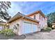 Two-car garage with white doors and paver driveway at 1962 Freedom Dr, Clearwater, FL 33755