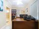 Home office with wood desk, two computer monitors, and built-in shelving at 1962 Freedom Dr, Clearwater, FL 33755