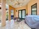 Covered patio with ceiling fan, grill, and outdoor seating at 1962 Freedom Dr, Clearwater, FL 33755