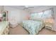 King-size bed, chair, and ample natural light in a carpeted bedroom at 2071 Australia W Way # 17, Clearwater, FL 33763