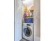 Neat laundry closet with washer, dryer, and shelving for storage at 2071 Australia W Way # 17, Clearwater, FL 33763