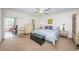 Spacious main bedroom with a king-size bed and access to balcony at 2071 Australia W Way # 17, Clearwater, FL 33763