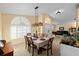 Spacious dining room with a wooden table and access to the living area at 2102 Golf Manor Blvd, Valrico, FL 33596