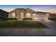 Tan house with arched entryway, American flag, and manicured lawn at 2102 Golf Manor Blvd, Valrico, FL 33596