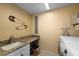 Convenient laundry room with washer, dryer, and utility sink at 2102 Golf Manor Blvd, Valrico, FL 33596