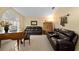 Living room with brown leather couches, piano and built-in shelving at 2102 Golf Manor Blvd, Valrico, FL 33596