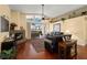 Living room features a stone fireplace, hardwood floors, and access to the lanai at 2102 Golf Manor Blvd, Valrico, FL 33596