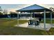 Picnic pavilion with table and benches near tennis courts at 2102 Golf Manor Blvd, Valrico, FL 33596