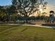 Playground with play structures and children playing near large oak tree at 2102 Golf Manor Blvd, Valrico, FL 33596