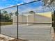 Racquetball court with white walls and chain link fence at 2102 Golf Manor Blvd, Valrico, FL 33596