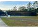 Tennis court with chain link fence and tennis balls at 2102 Golf Manor Blvd, Valrico, FL 33596