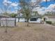 Spacious backyard with storage shed and mature tree at 2104 W Okaloosa Ave, Tampa, FL 33604