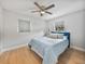 Cozy bedroom with light blue bedding and ceiling fan at 2104 W Okaloosa Ave, Tampa, FL 33604