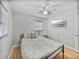 Bedroom with patterned bedding and ceiling fan at 2104 W Okaloosa Ave, Tampa, FL 33604