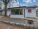 White house exterior with a sunroom and fire pit in the backyard at 2104 W Okaloosa Ave, Tampa, FL 33604