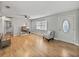 Spacious living room featuring hardwood floors, neutral walls and a comfy armchair at 2104 W Okaloosa Ave, Tampa, FL 33604