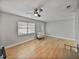 Living room with hardwood floors, a ceiling fan, and plenty of natural light at 2104 W Okaloosa Ave, Tampa, FL 33604