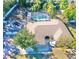 Aerial view of single-story home with pool and lush landscaping at 2142 Hickory Gate W Dr, Dunedin, FL 34698