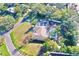 An elevated view of a house with a pool and surrounding greenery at 2142 Hickory Gate W Dr, Dunedin, FL 34698