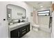 Clean bathroom with grey vanity and bathtub at 2142 Hickory Gate W Dr, Dunedin, FL 34698