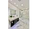 Modern bathroom with marble shower and floating vanity at 2142 Hickory Gate W Dr, Dunedin, FL 34698