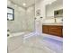 Modern bathroom with marble shower and floating vanity at 2142 Hickory Gate W Dr, Dunedin, FL 34698