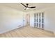 Simple bedroom with light wood floors and closet at 2142 Hickory Gate W Dr, Dunedin, FL 34698