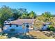 White single story home with a brown roof at 2142 Hickory Gate W Dr, Dunedin, FL 34698