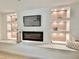 Modern fireplace with built-in shelving and ambient lighting at 2142 Hickory Gate W Dr, Dunedin, FL 34698