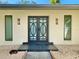 Modern double front doors with geometric glass at 2142 Hickory Gate W Dr, Dunedin, FL 34698