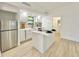 Modern kitchen with white cabinets and quartz island at 2142 Hickory Gate W Dr, Dunedin, FL 34698