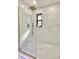 Large walk-in shower with marble tile and glass enclosure at 2142 Hickory Gate W Dr, Dunedin, FL 34698