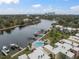 Aerial view of waterfront community with pool, boat docks, and city skyline in background at 2424 W Tampa Bay Blvd # L102, Tampa, FL 33607