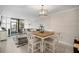 Bright dining area with wood table and white chairs, adjacent to living room at 2424 W Tampa Bay Blvd # L102, Tampa, FL 33607